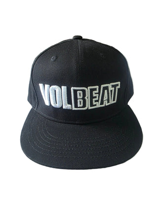 A black snapback cap with 'VOLBEAT' embroidered in white and black across the front